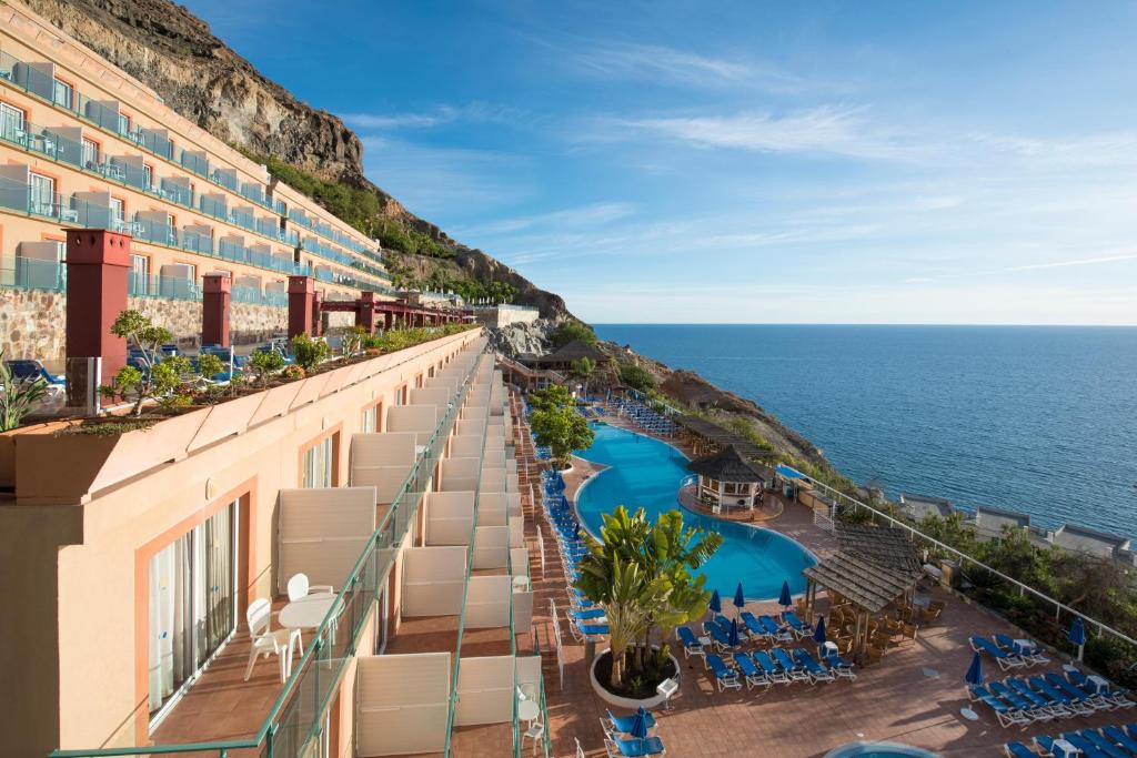 a view of the ocean from the balcony of a hotel at Mogan Princess & Beach Club in Taurito