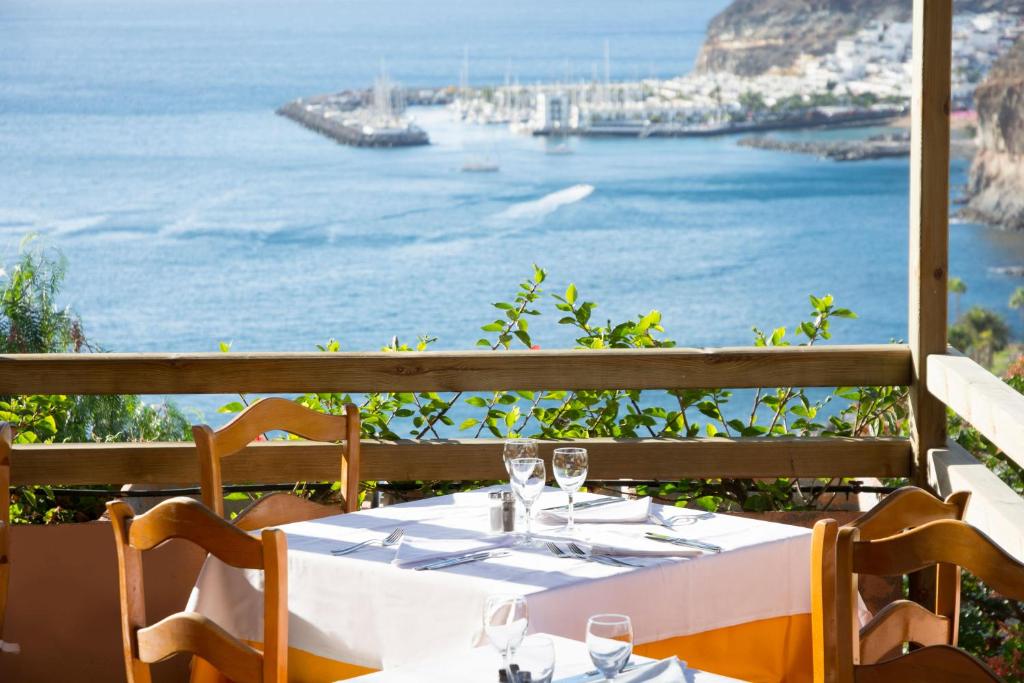 a table with a view of the ocean at Mogan Princess & Beach Club in Taurito