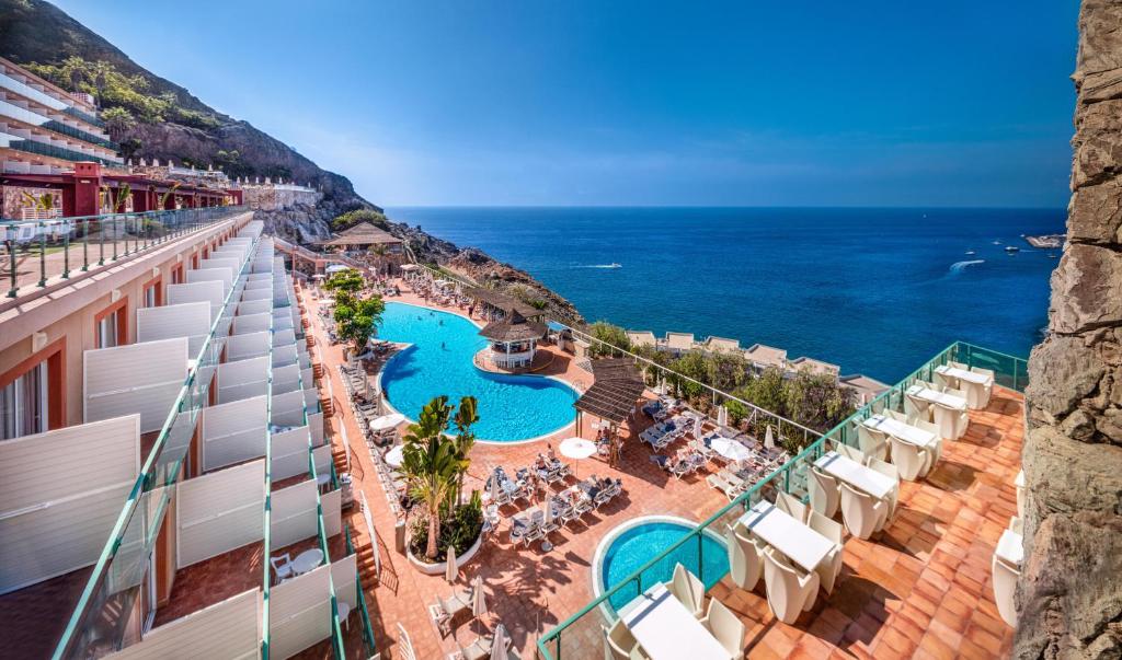 a view of the ocean from the balcony of a resort at Mogan Princess & Beach Club in Taurito
