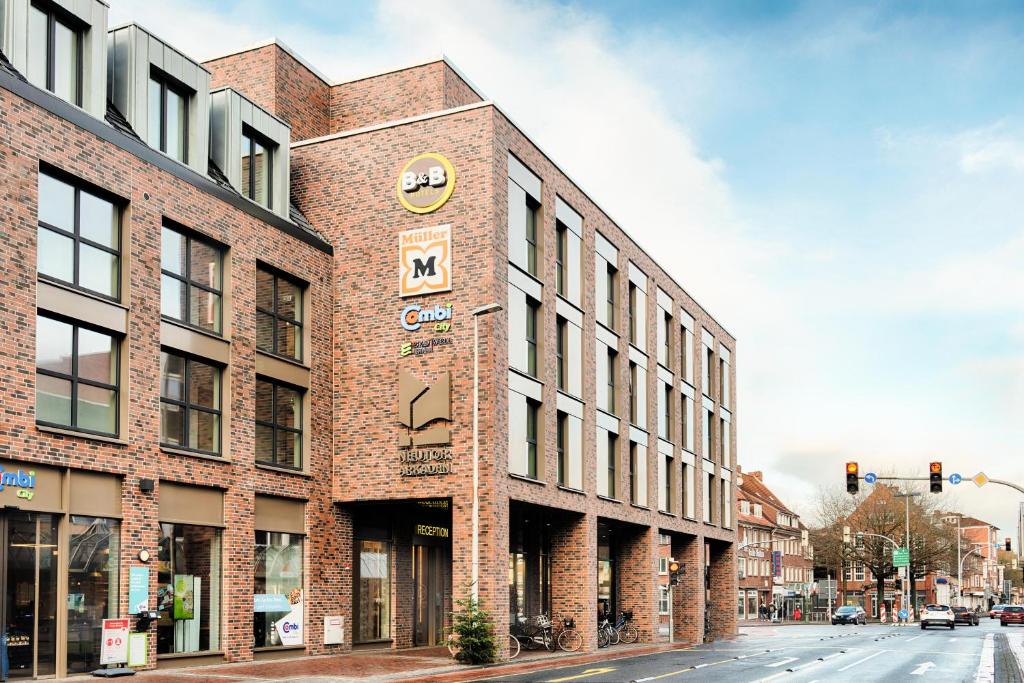 a brick building on the corner of a street at B&B Hotel Emden in Emden