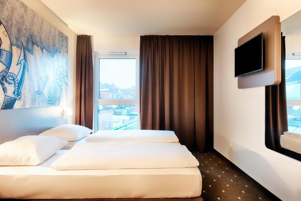 Postel nebo postele na pokoji v ubytování B&B Hotel Emden