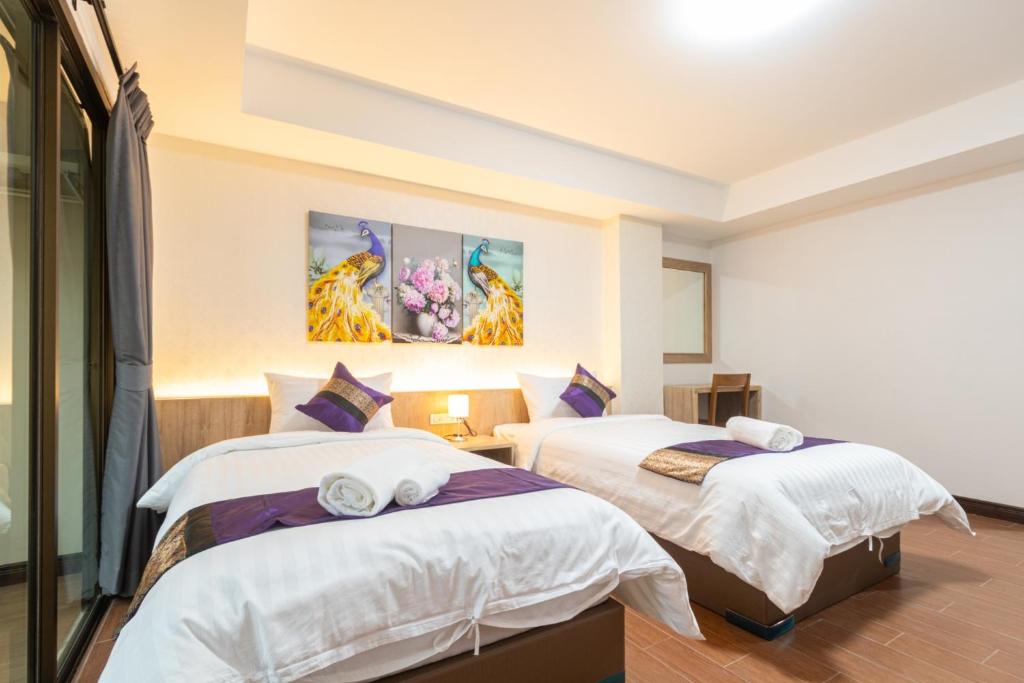 Postel nebo postele na pokoji v ubytování Peacock De Pai Hotel