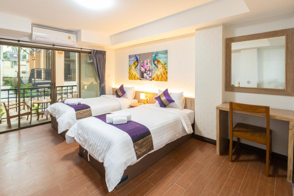 Postel nebo postele na pokoji v ubytování Peacock De Pai Hotel