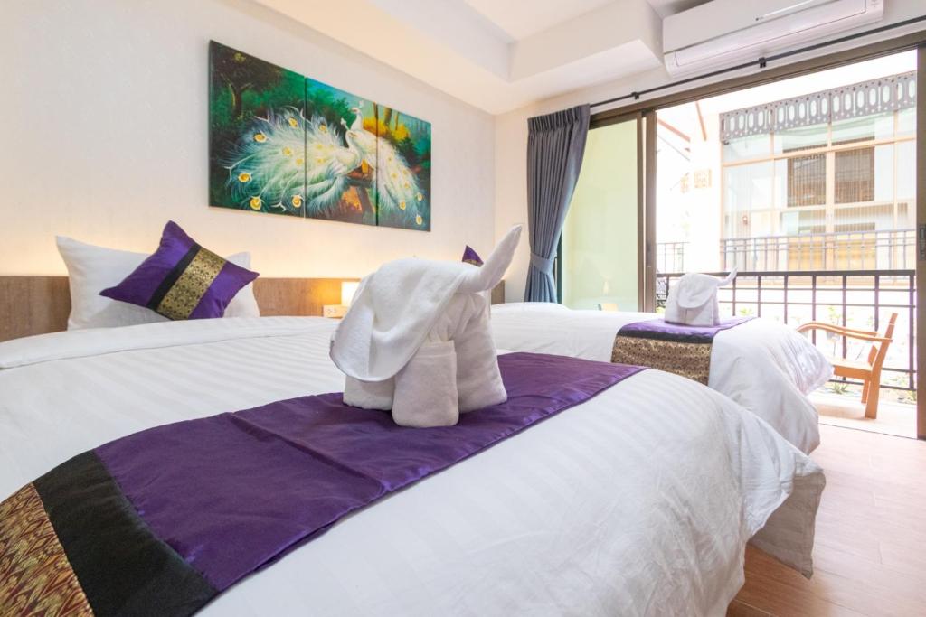 Postel nebo postele na pokoji v ubytování Peacock De Pai Hotel