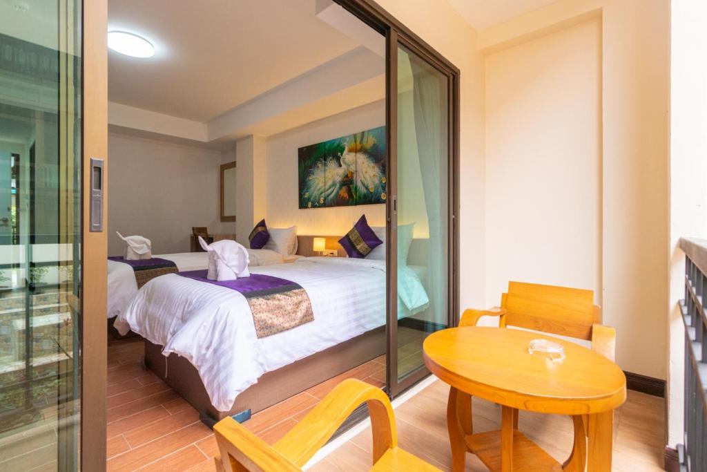 Postel nebo postele na pokoji v ubytování Peacock De Pai Hotel
