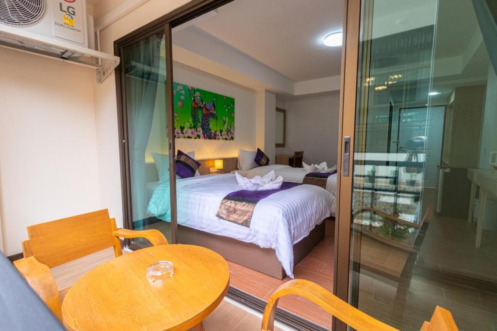 Postel nebo postele na pokoji v ubytování Peacock De Pai Hotel