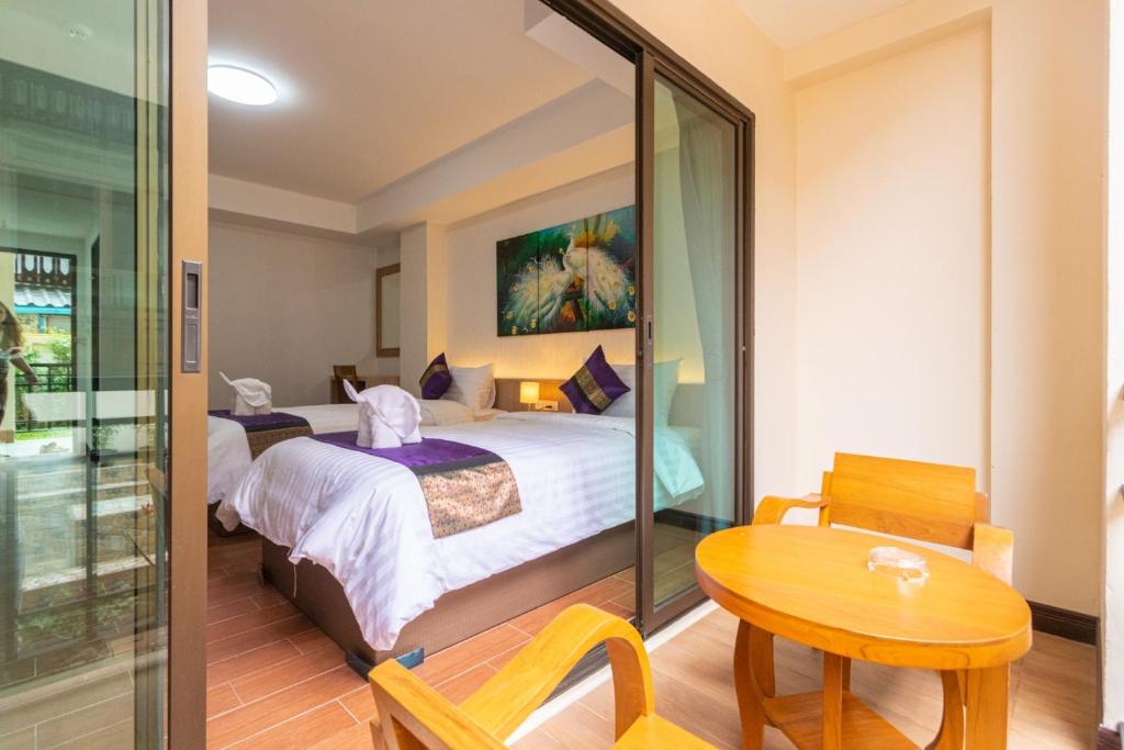 Postel nebo postele na pokoji v ubytování Peacock De Pai Hotel