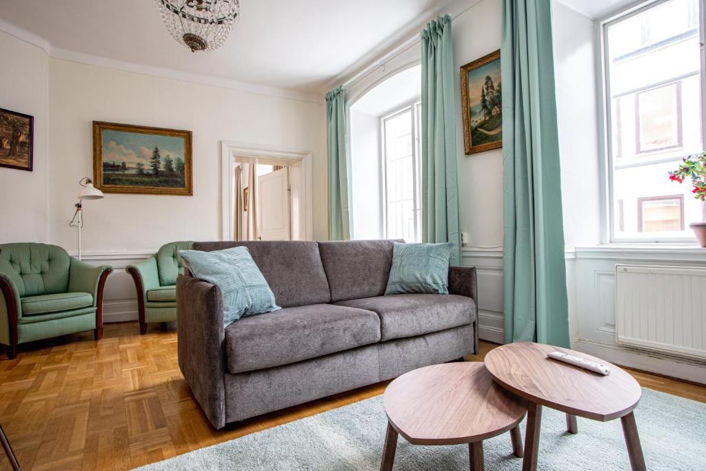 a living room with a couch and two chairs at ApartDirect Gamla Stan II in Stockholm