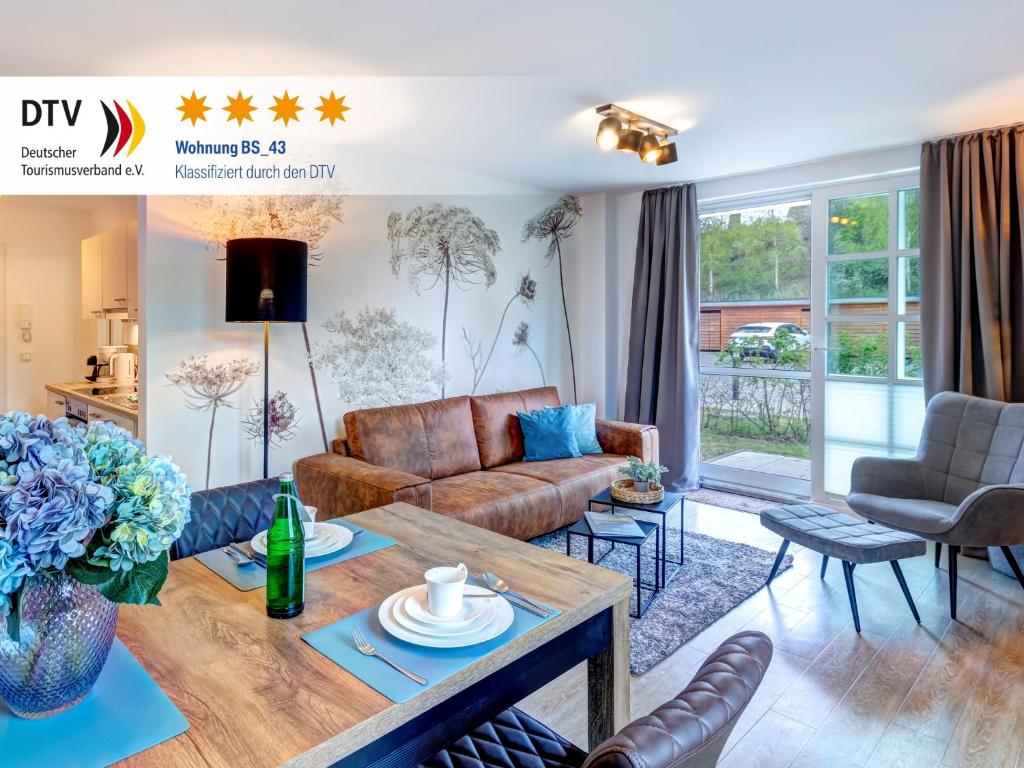 a living room with a couch and a table at Residenz am Balmer See - BS 43 mit Wellnessbereich in Balm