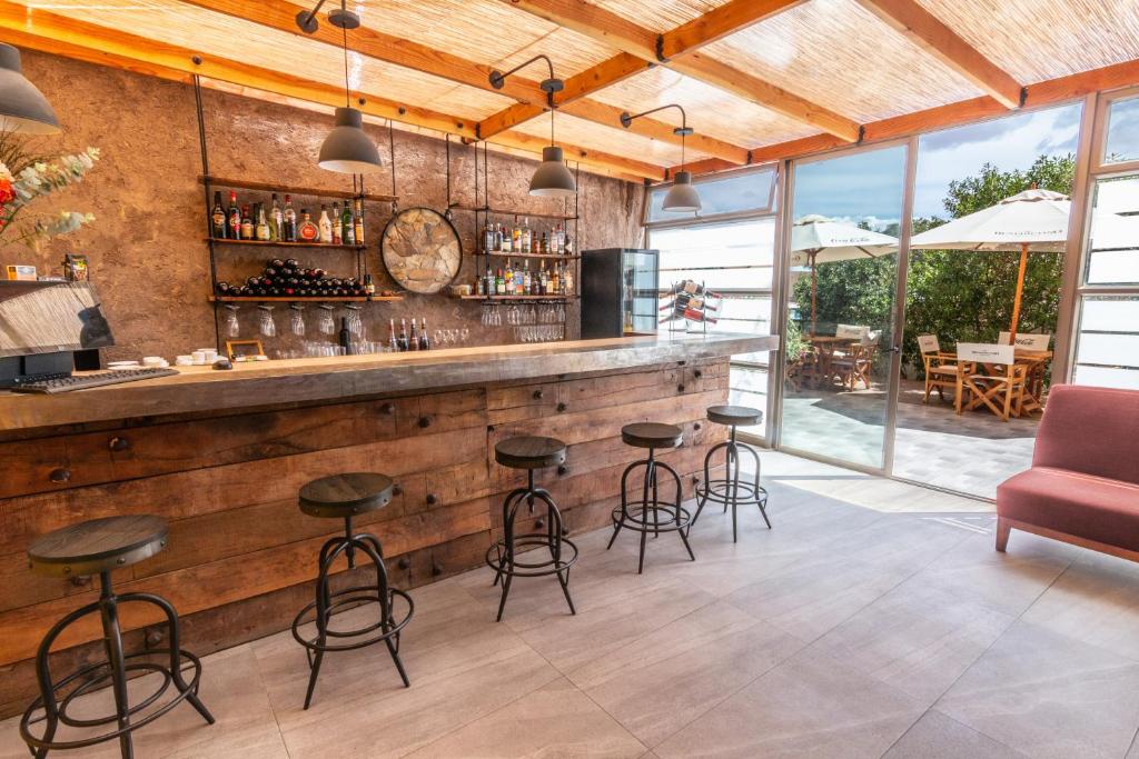 a bar in a restaurant with a red chair at Geotel Calama in Calama