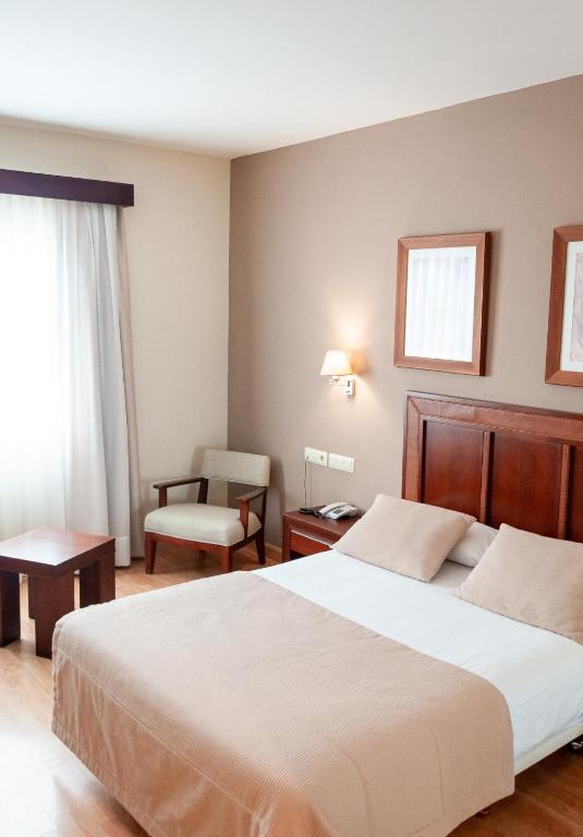 Postel nebo postele na pokoji v ubytování ARVA Santiago León