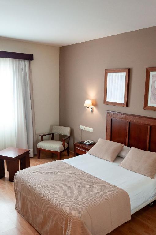 Postel nebo postele na pokoji v ubytování ARVA Santiago León