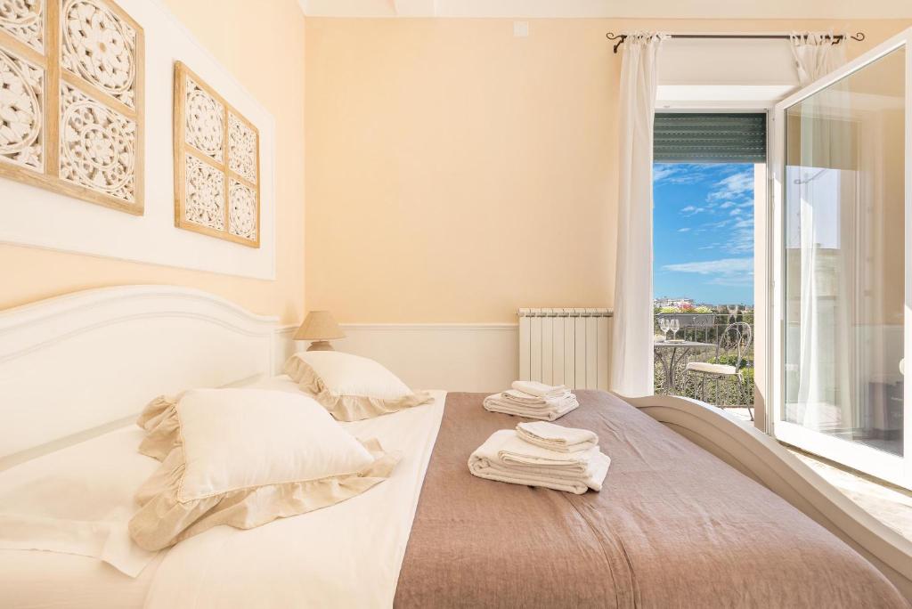 Postel nebo postele na pokoji v ubytování Dimora Le Tre Muse Guesthouse