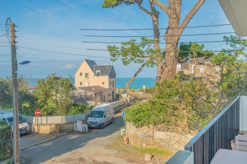 a view of a street with a house and a van at La mer à vos pieds, la plage à 50m in Dinard