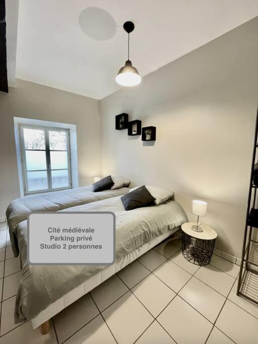 a bedroom with a bed with a sign on it at *Au centre de la ville haute G* ZEN LOC 6 in Provins