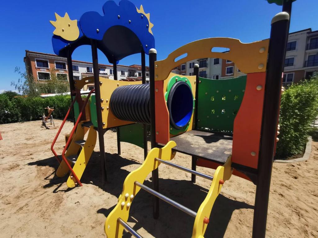 a playground with a play equipment in the sand at Lily Beach - Apartment 408A in Sozopol