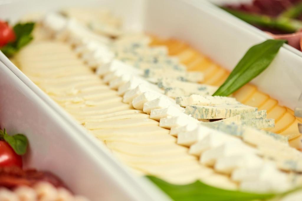a tray of cheese and crackers in a container at Hotel Srbija Garden-FREE PARKING in Belgrade