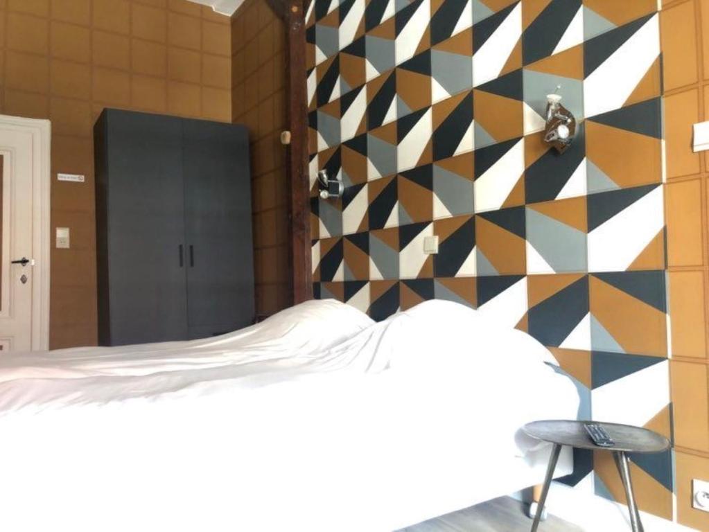 Postel nebo postele na pokoji v ubytování Hotel Le Limbourg