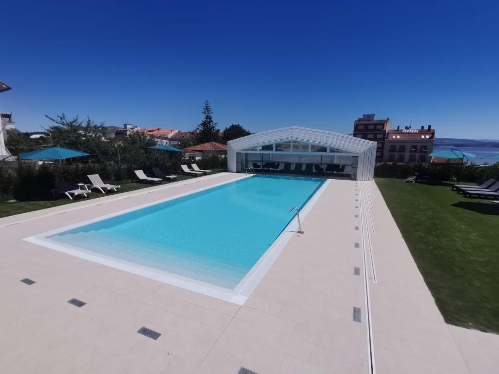 a large swimming pool on top of a building at Apartamentos La Toja in O Grove