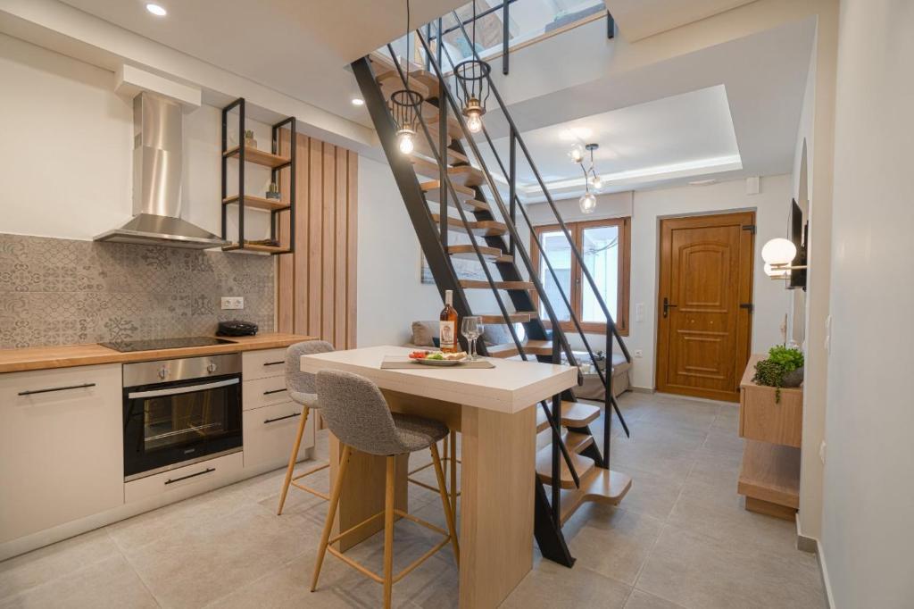 a kitchen with a spiral staircase and a table and chairs at Jacuzzi maisonette in Sfakia center 'New 2023' in Hora Sfakion