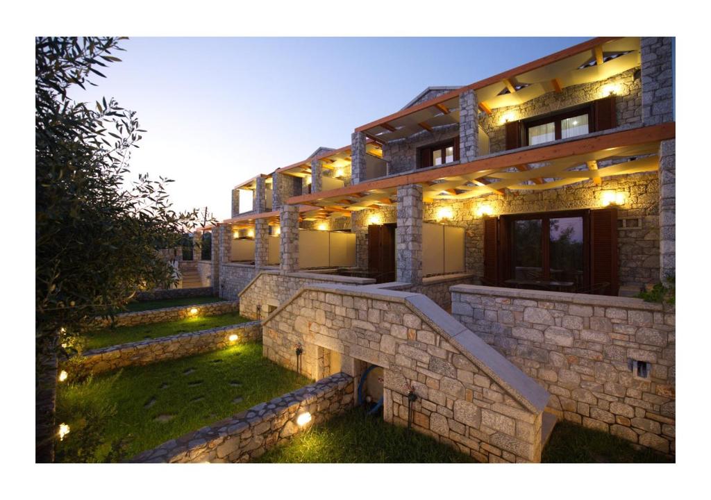a building with lights on the side of it at MANI HOUSES Selinitsa Art Koloveas in Agios Nikolaos