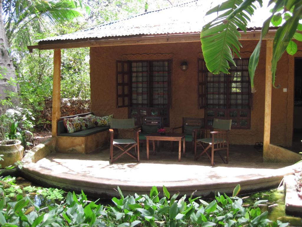 a house in the middle of a garden at Boko Boko Guesthouse and Hotel in Kikambala