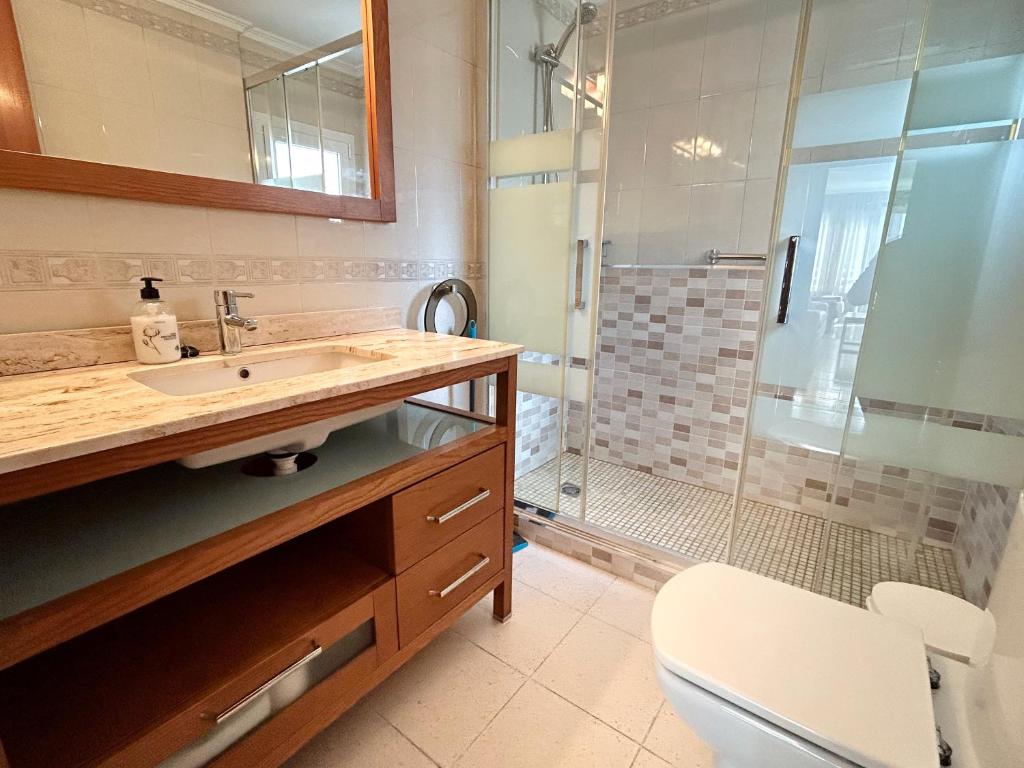 a bathroom with a sink and a shower at Domo 5E Holiday apt with pool in Benidorm
