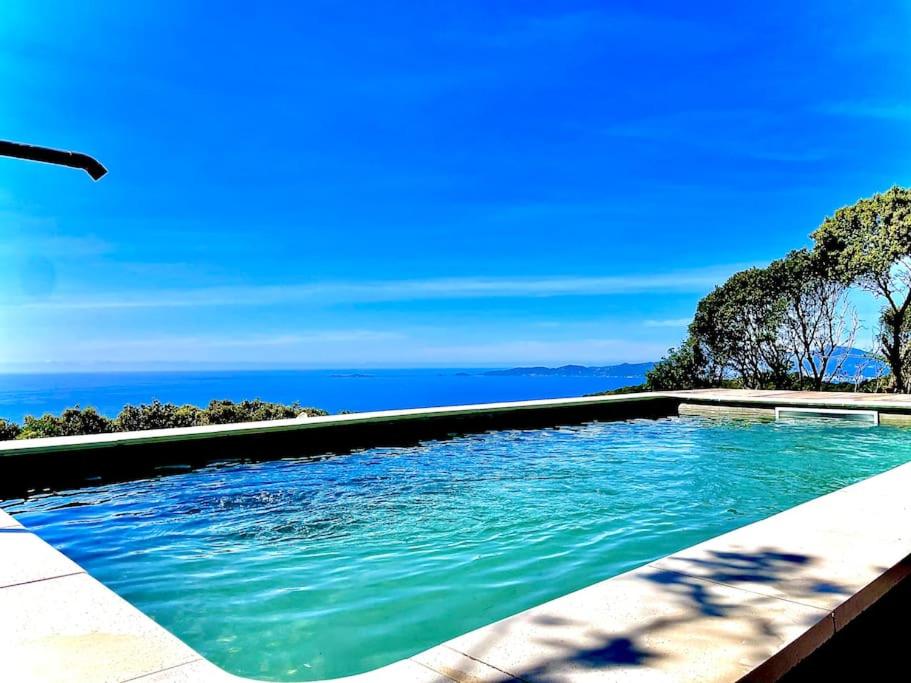 a swimming pool with the ocean in the background at Casa Altura in Coti-Chiavari