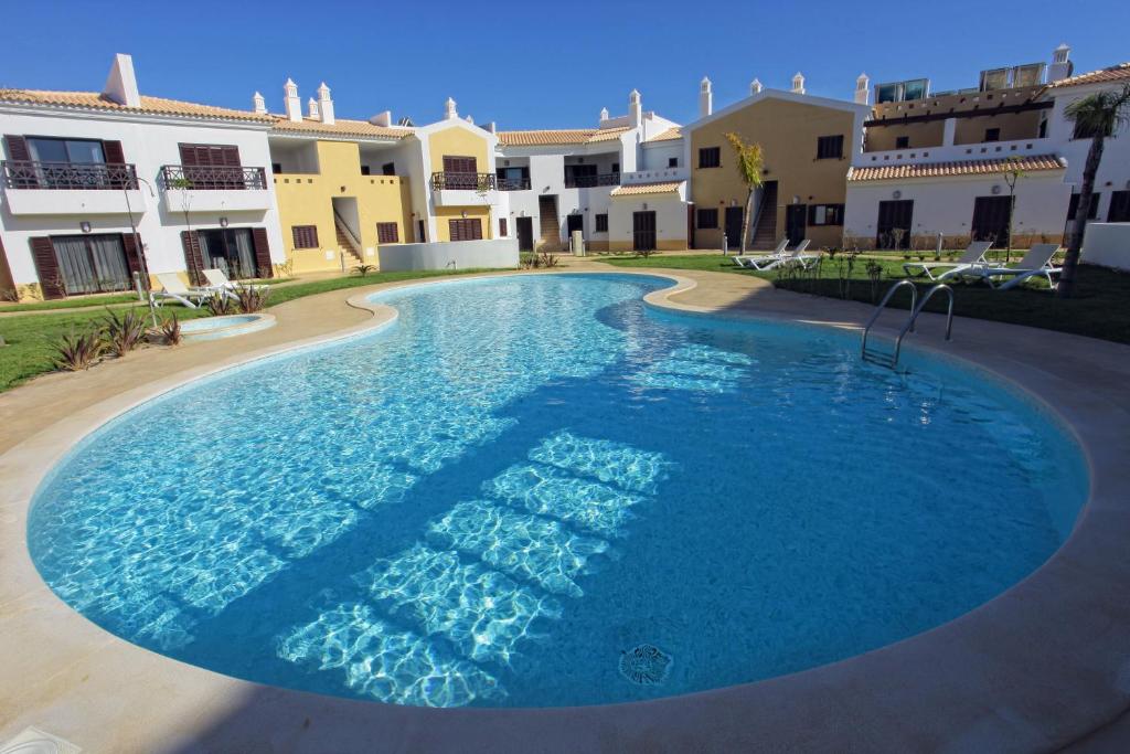 a large swimming pool in front of some buildings at Sagres Time Apartamentos in Sagres