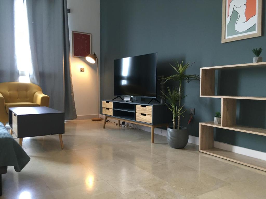a living room with a flat screen tv on a entertainment center at CriteriaHome! nice&easy in Madrid
