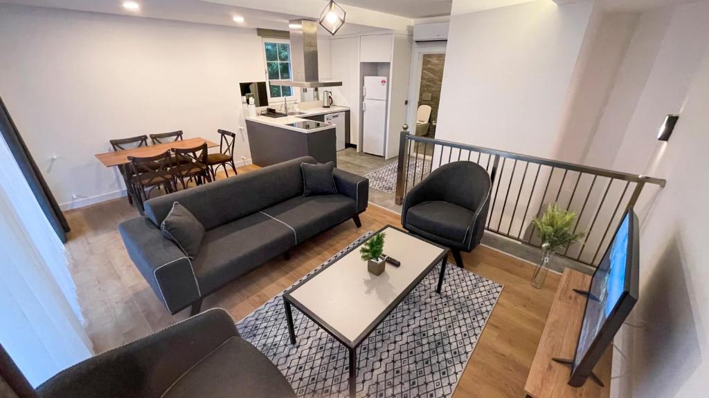 a living room with a couch and a tv at A suites in Antalya