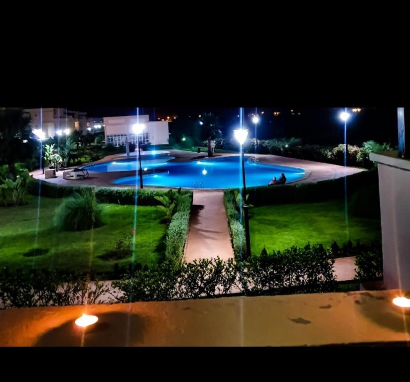a large swimming pool at night with lights at Résidence Ap13 in Saidia 