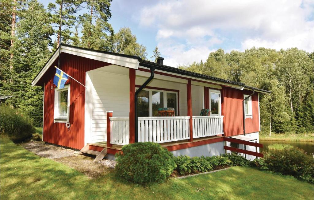 een rood-wit tiny house met een balkon bij 2 Bedroom Amazing Home In Mjback in Knapasjö