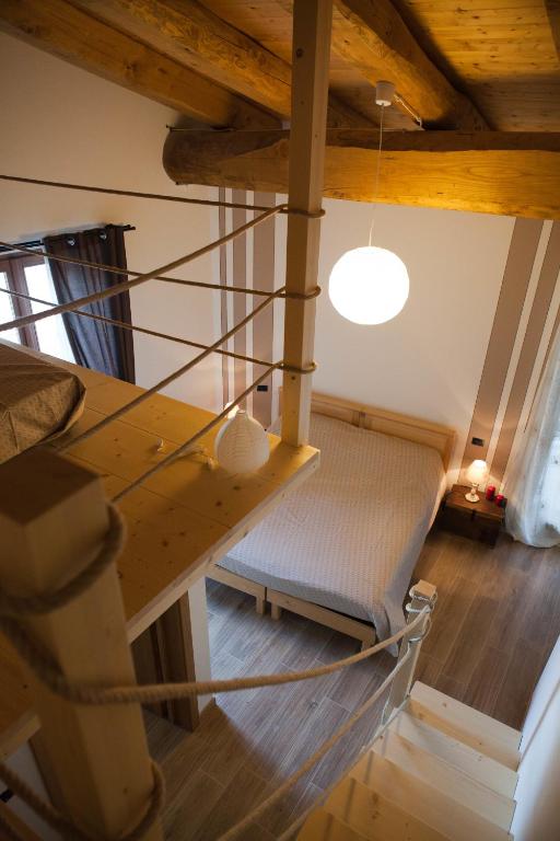 an attic room with a staircase and a light at Affittacamere La Lea in Roccaforte Mondovì