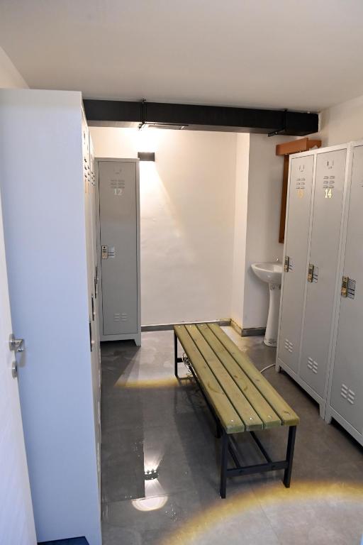 a locker room with a bench in a room with lockers at Safir Hotels Silivri in Silivri