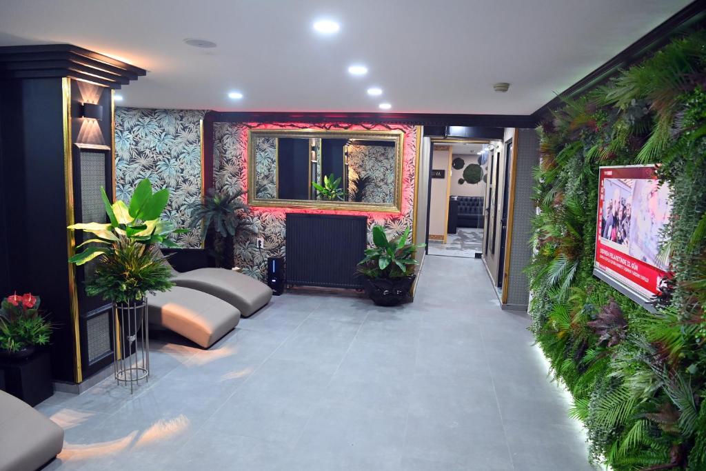 a living room with plants on the walls at Safir Hotels Silivri in Silivri