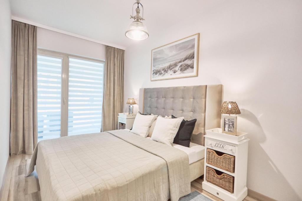 Posteľ alebo postele v izbe v ubytovaní Apartament Riviera z tarasem - Playa Baltis