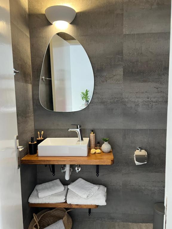 a bathroom with a sink and a mirror at Fatolitis Studios in Masouri