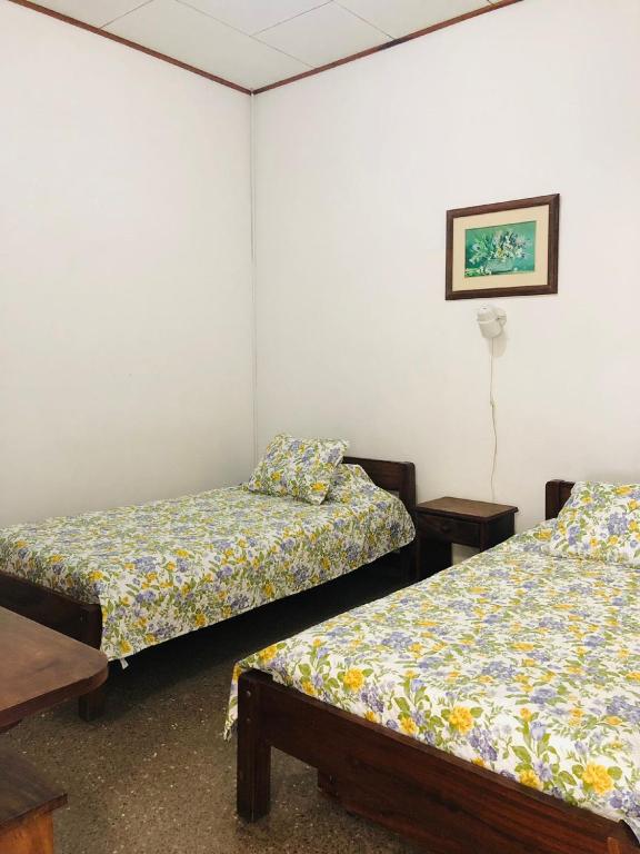 Postel nebo postele na pokoji v ubytování Hotel Del Aserradero