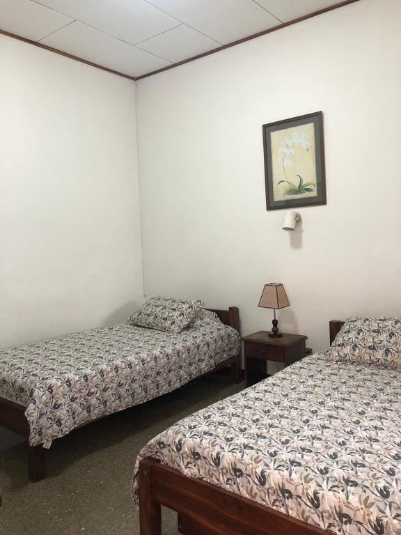 Postel nebo postele na pokoji v ubytování Hotel Del Aserradero