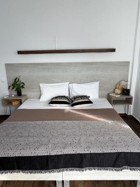 a bedroom with a large bed with two pillows at Fatolitis Studios in Masouri