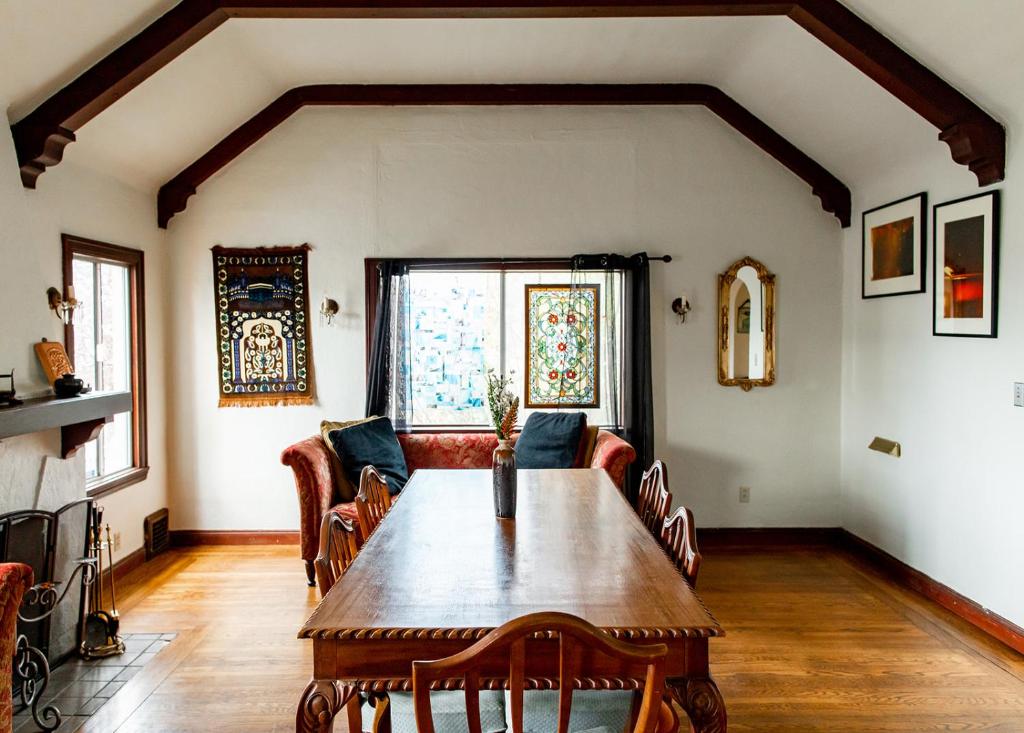 a living room with a wooden table and chairs at Beautiful, Historic Family Home near Lake Merritt in Oakland