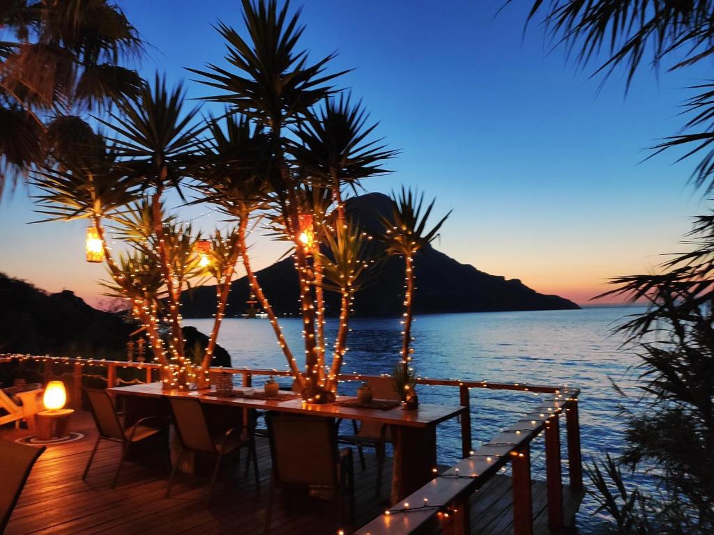 a dinner table on the beach at night at Fatolitis Studios in Masouri