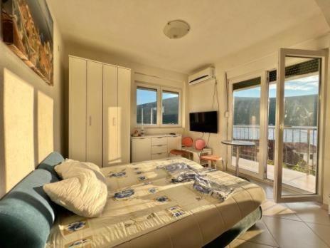 ein Schlafzimmer mit einem großen Bett und ein Wohnzimmer in der Unterkunft Vamos a la playa - Djenovici in Ðenovići