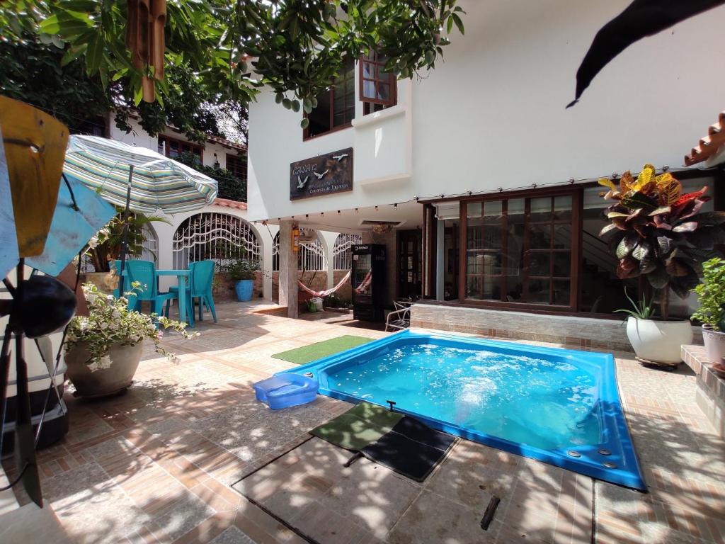 a swimming pool in front of a house at Ayenda Casa 12 in Santa Marta