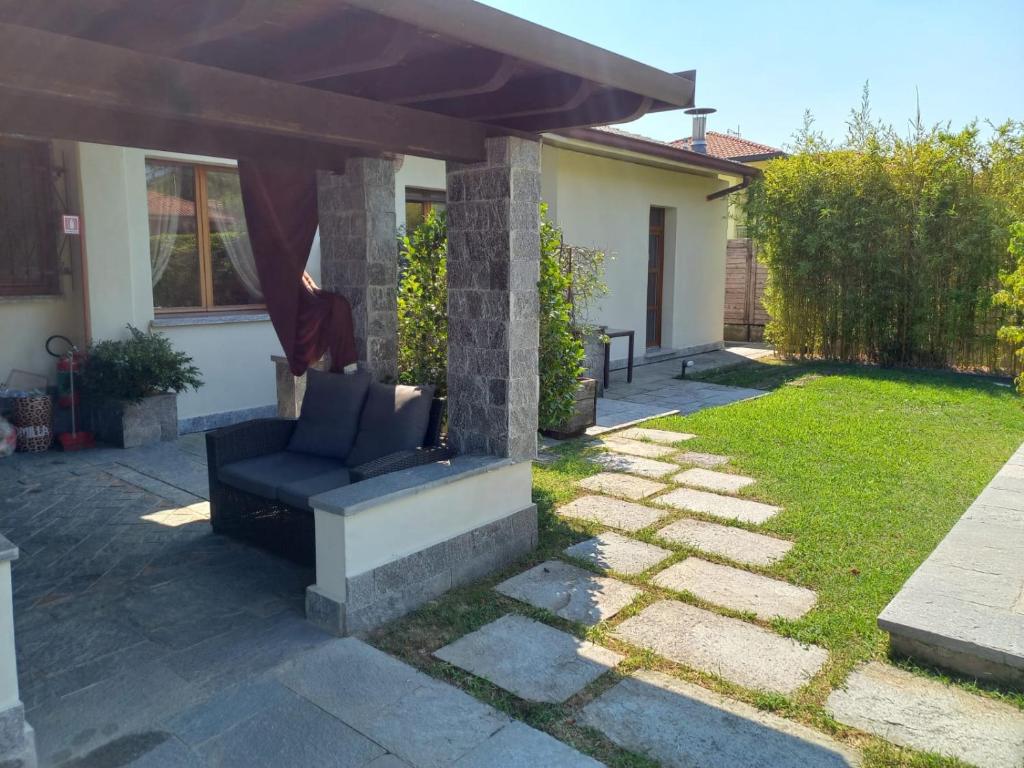 eine Terrasse mit einem Sofa im Hof in der Unterkunft RESIDENZA BERETTA Como Lake -A- in Orsenigo