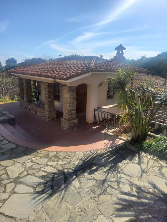 a small house with a tile roof on a patio at Villa Rosa in Latte
