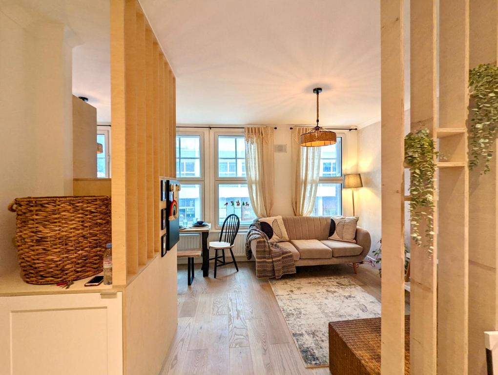 a living room with a couch and a table at Trafalgar House Apartment in Beckenham