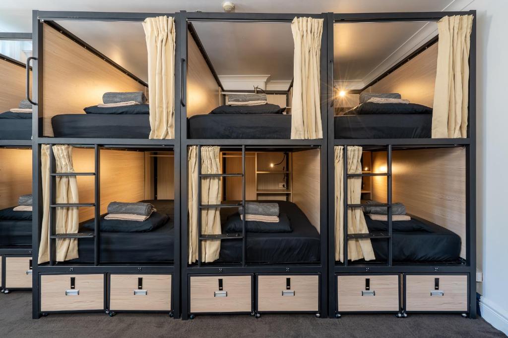 a room with four bunk beds in it at Tequila Sunrise Hostel Sydney in Sydney