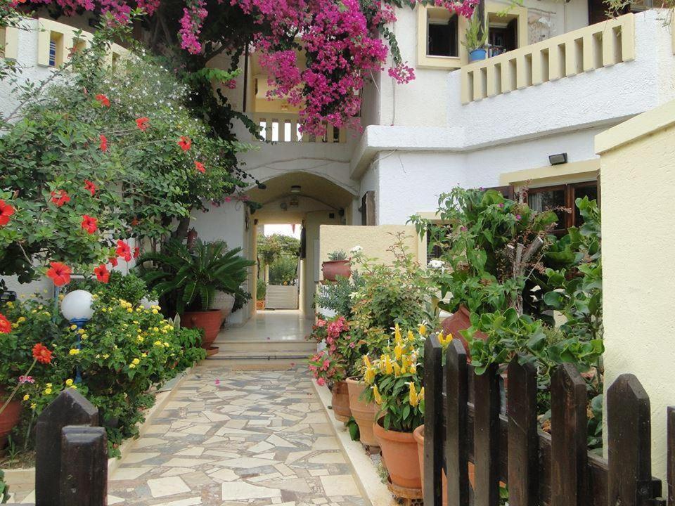 a building with flowers and plants on it at Paradise Inn in Milatos